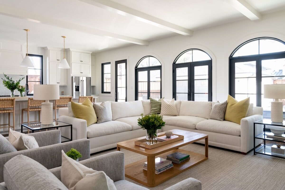 Photo of living room area with big windows and leather seating