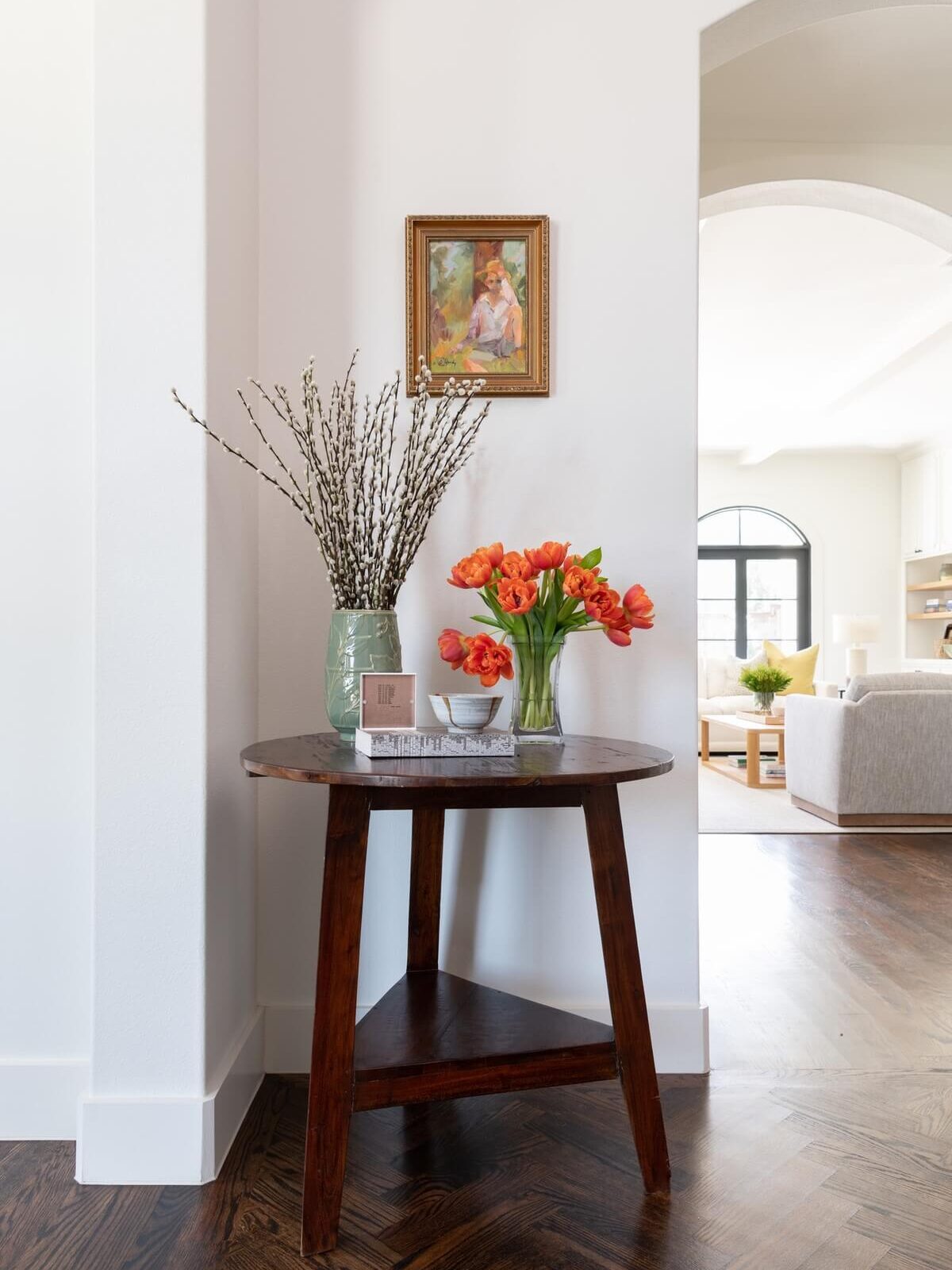 Corner room table with orange flowers in a crystal glass displayed on top