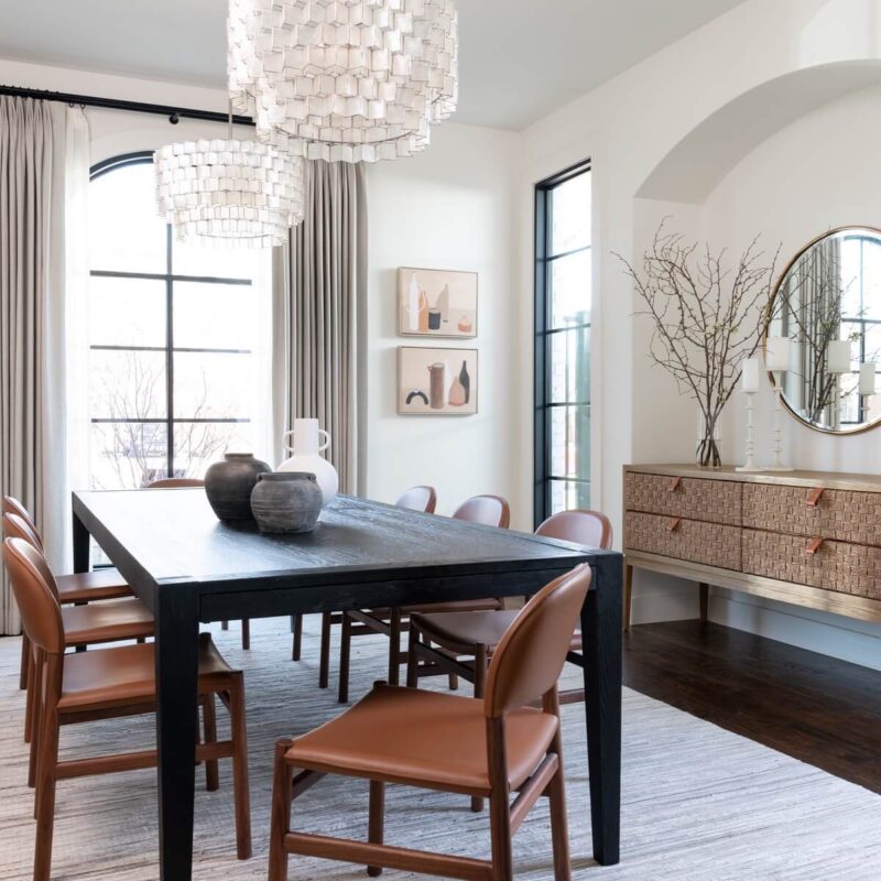 View of tan leather dining chairs around dark dining table