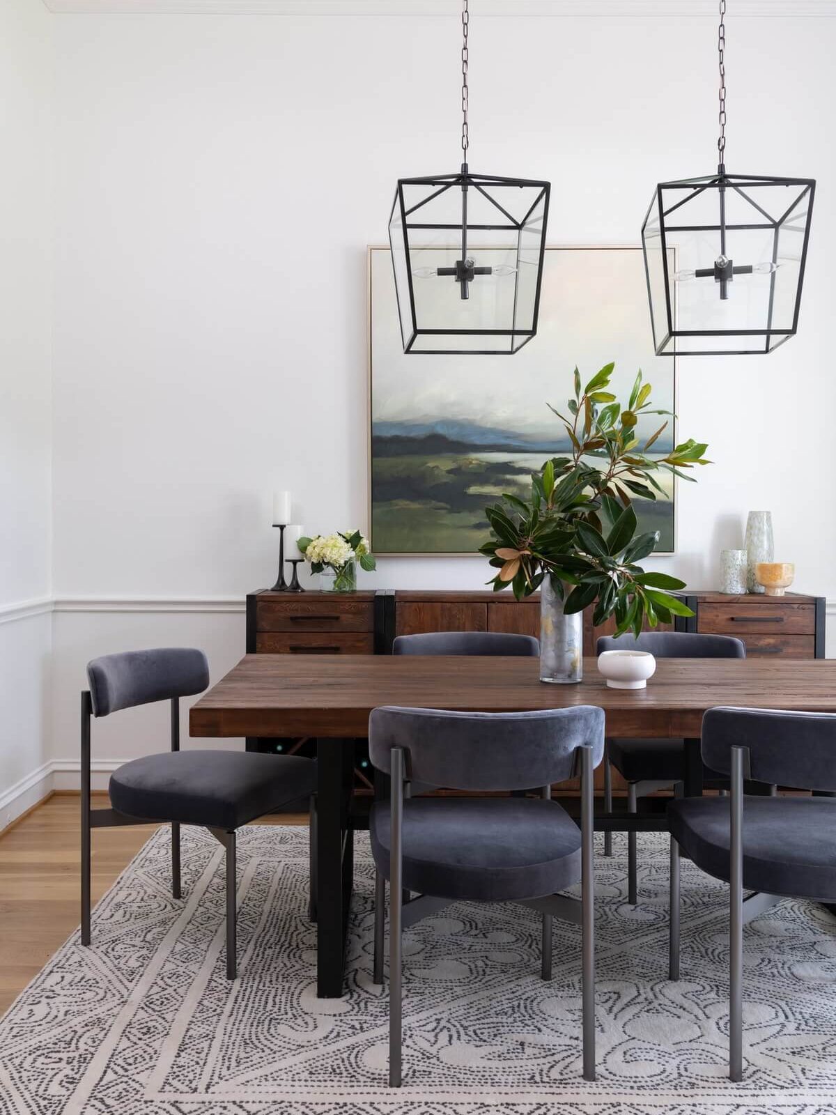 Dining table with cast iron framed dining chairs and hanging pendant lamps